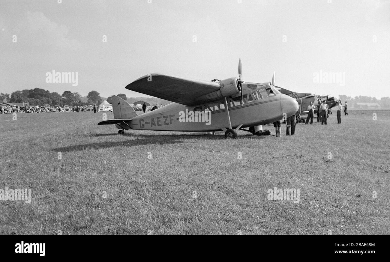 Vintage black and white photograph showing a Short S16 Scion 2 aeroplane, registration number G-AEZF, at an airfield in England during the 1950s. Stock Photo