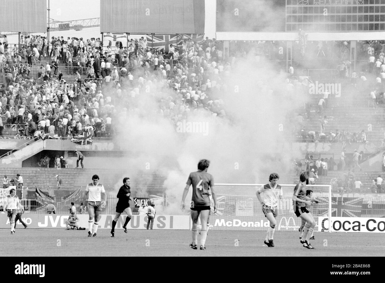 Clouds of tear gas rise from the terraces behind the England goal as Italian riot police try to control the hooligan element amongst the England following Stock Photo