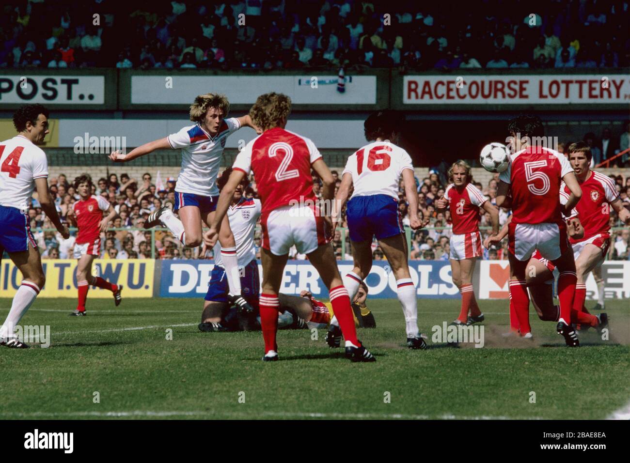 England's Paul Mariner (fourth r) deflects a shot from teammate Peter Barnes (second l) into the Wales net, via the shoulder of Wales's David Jones (second r), for England's only goal of the game, watched by teammates Ray Kennedy (l) and Larry Lloyd (third l) and Wales's Joey Jones (r), Terry Yorath (third r), Paul Price (fourth l) and Dai Davies (on floor) Stock Photo