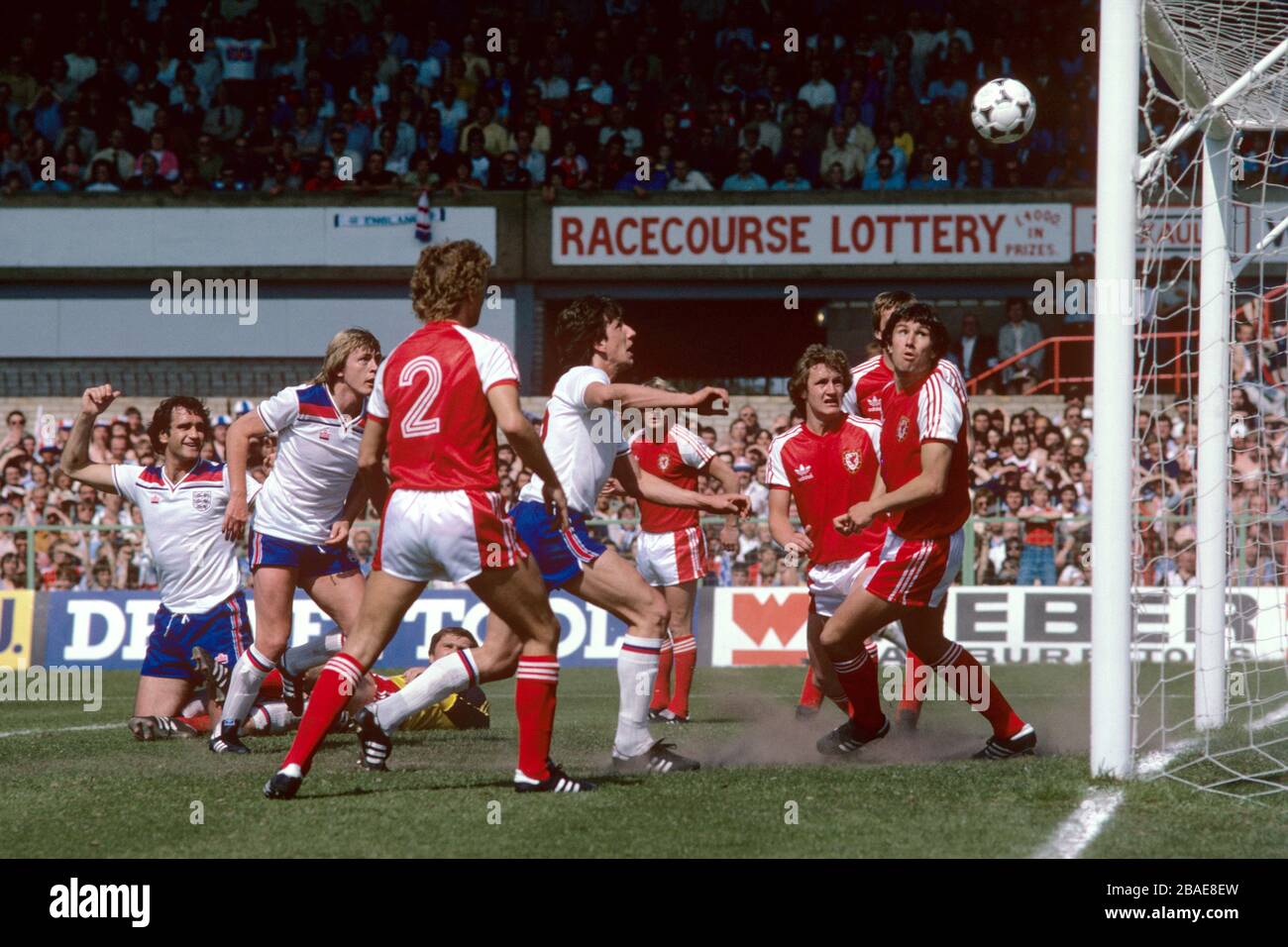 England's Paul Mariner (c) heads home his team's only goal, watched by teammates Larry Lloyd (l) and Peter Barnes (second l), and Wales's David Jones (r), Joey Jones (r, hidden), Peter Nicholas (third r), Terry Yorath (fourth r, half hidden), Paul Price (third l) and Dai Davies (l, on floor) Stock Photo