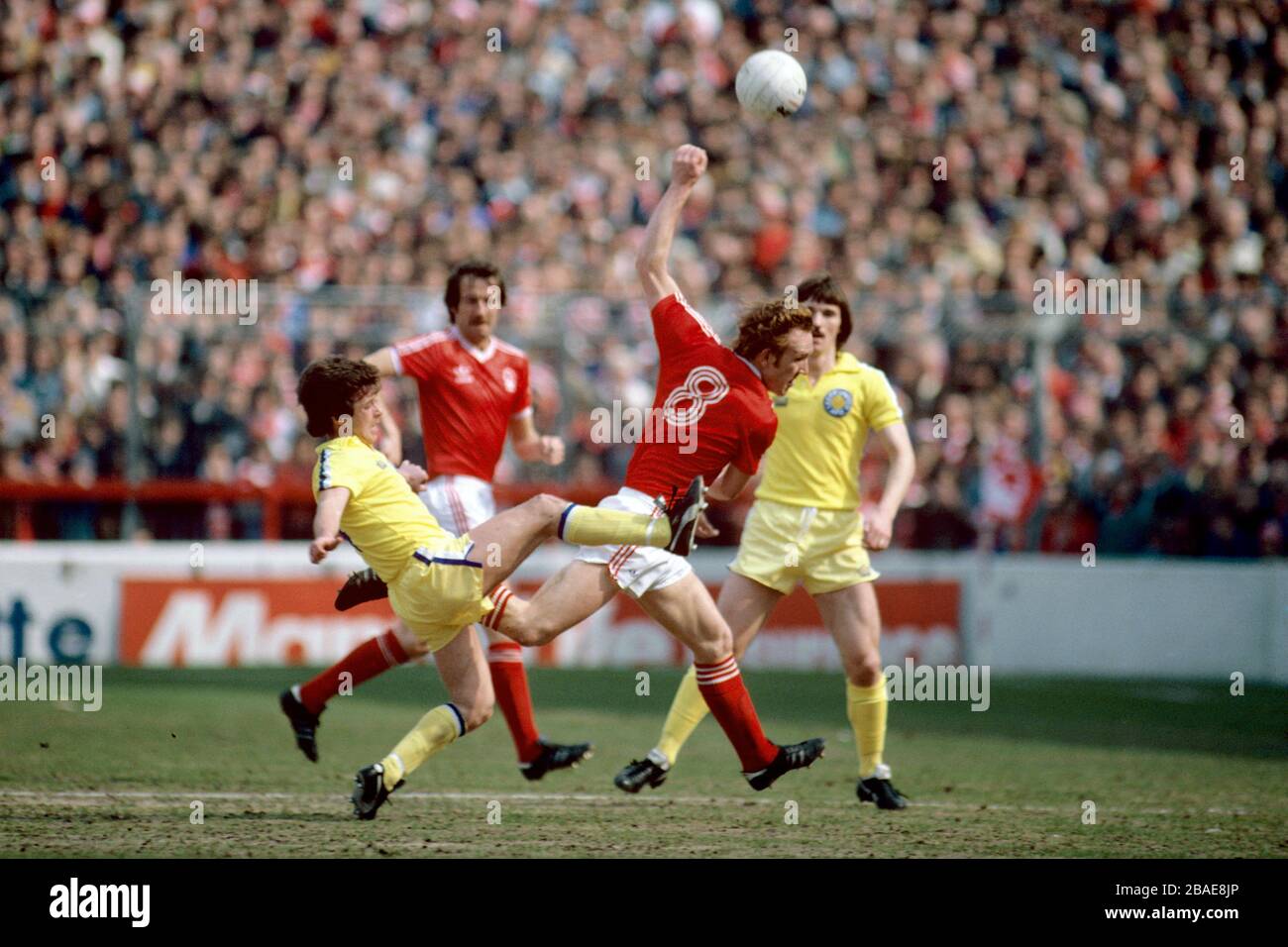 Leeds United's Brian Flynn (l) clears from Nottingham Forest's Ian Bowyer (second r), as Leeds' Carl Harris (r) and Forest's Frank Clark (second l) look on Stock Photo