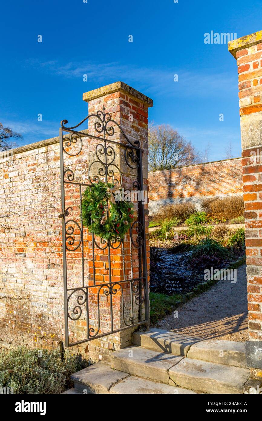 Decorative Christmas wreaths on a gate in the walled garden at Stourhead House, Wiltshire, England, UK Stock Photo