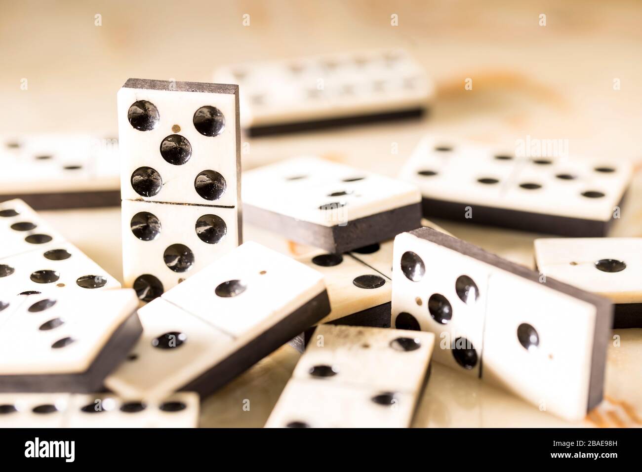 Domino as an abstract concept. Beautiful antique domino set on marble chess board. Stock Photo