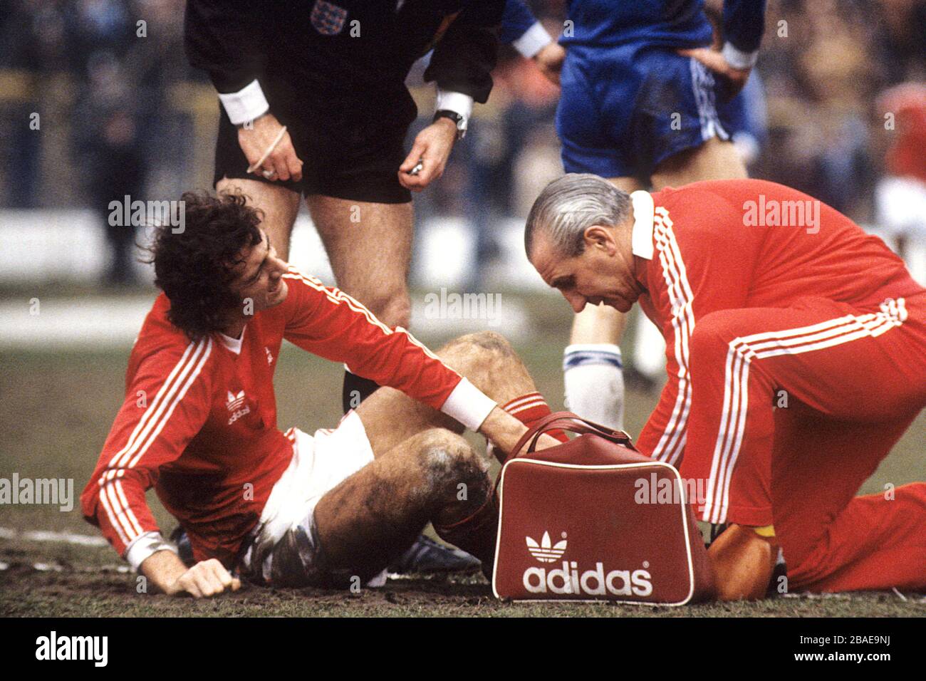 Nottingham Forest's Trevor Francis is treated for an injury by trainer Jimmy Gordon. Stock Photo