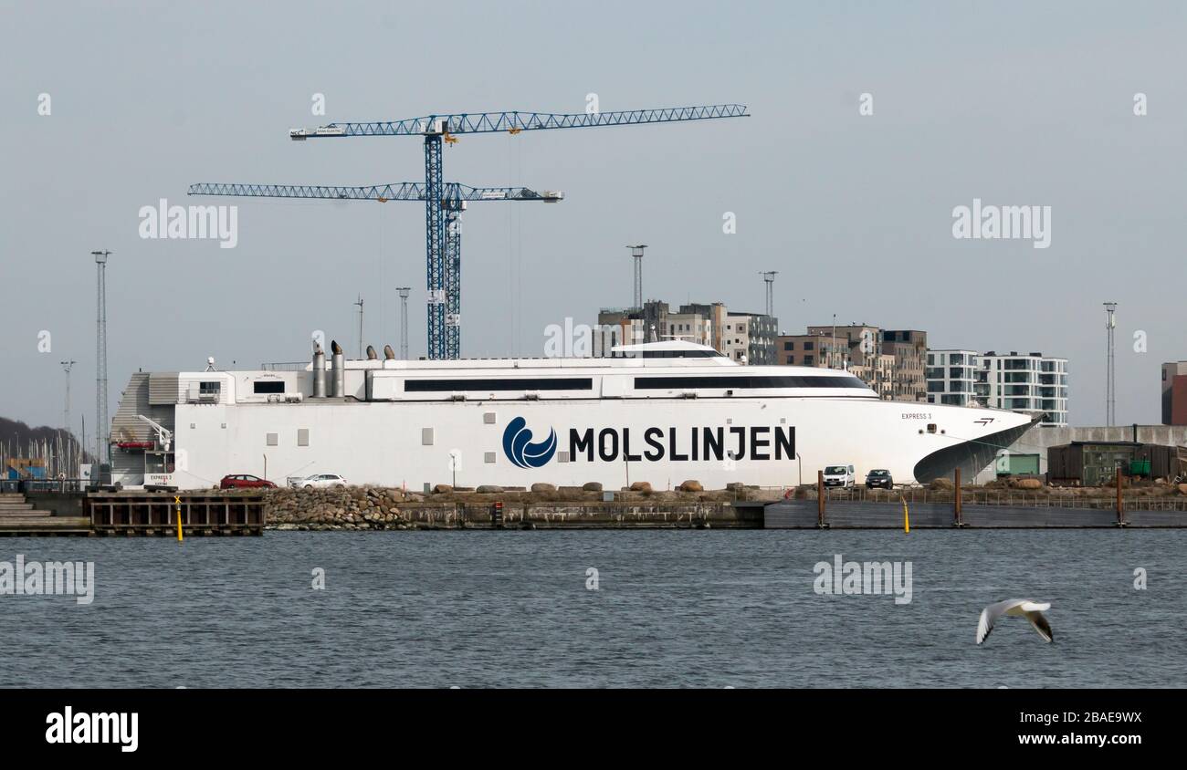 Aarhus, Denmark - 24 march 2020:  The high-speed ferry EXPRESS 3 of the shipping company Molslinjen is moored at the pier in the port of Aarhus Stock Photo