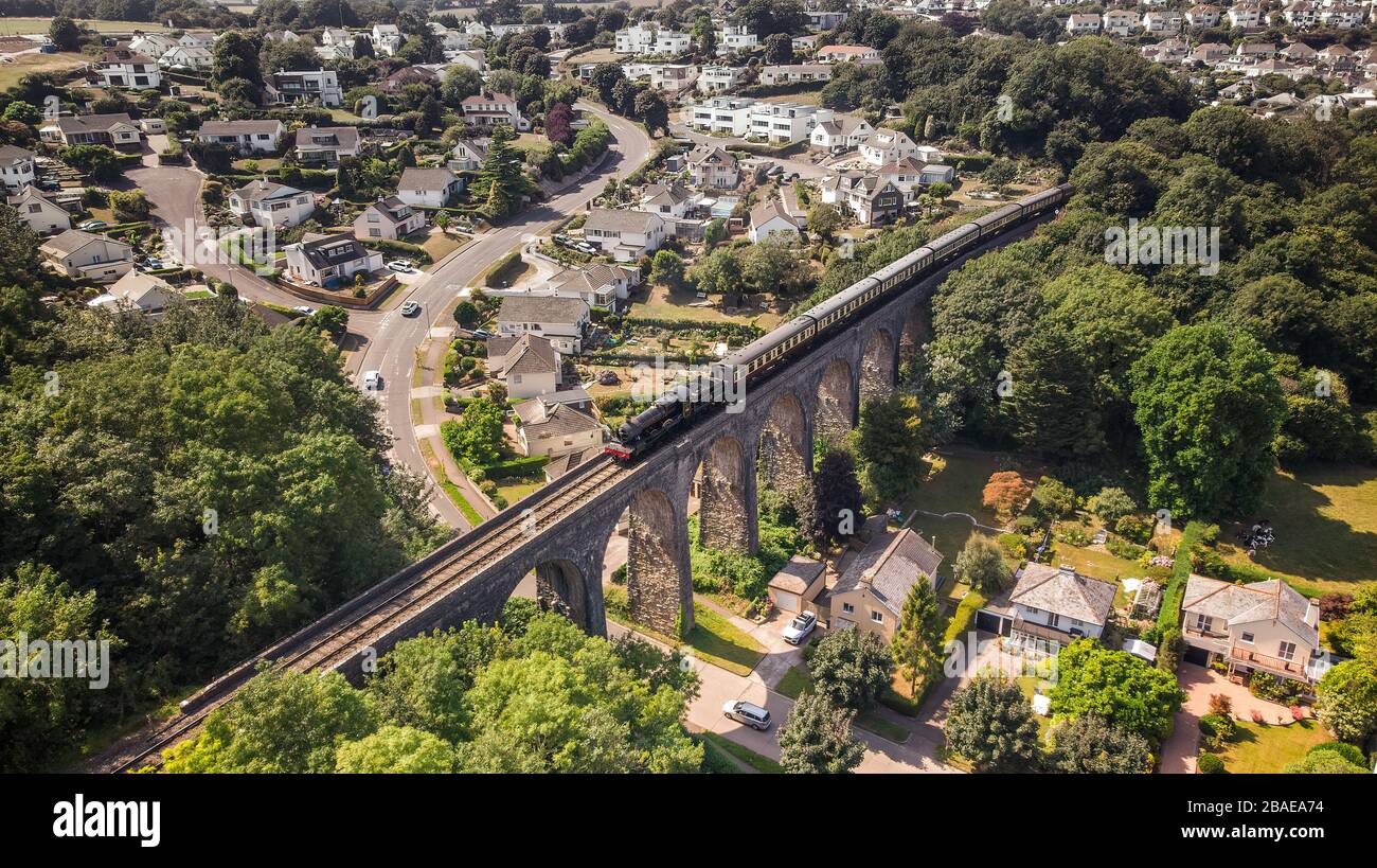 Aerial drone view of the Dartmouth Steam railway locomotive passing over the broadsands viaduct Stock Photo