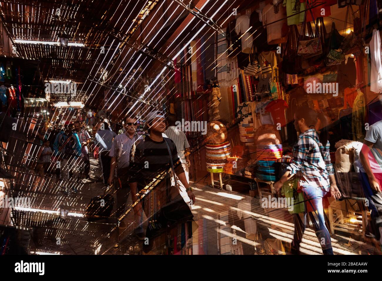 Busy street scene inside the medina, old town, with people shopping, November 6, 2017, Marrakech, Morocco. Double exposure image. Stock Photo