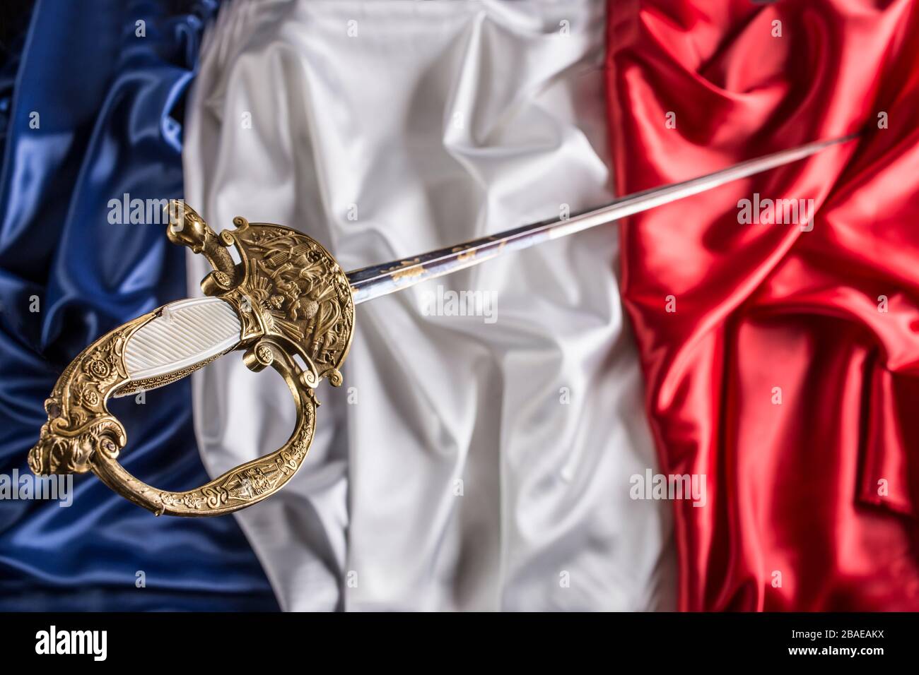 French officer court sword (shortsword) an silk French flag background.The 19th century. France. Stock Photo