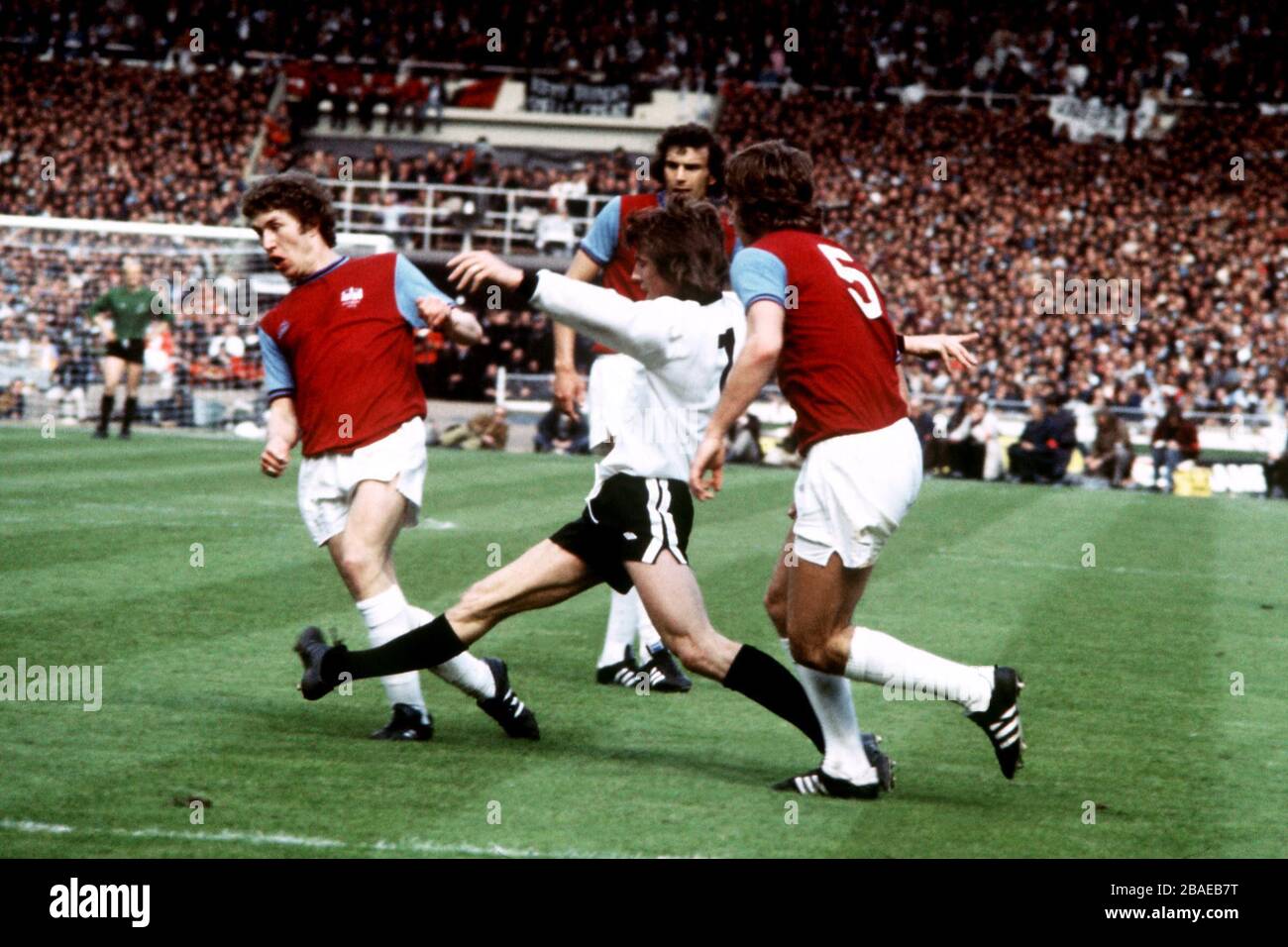 L-R; Pat Holland (West Ham), John Mitchell (Fulham) and Tommy Taylor (West Ham) battle for the ball Stock Photo