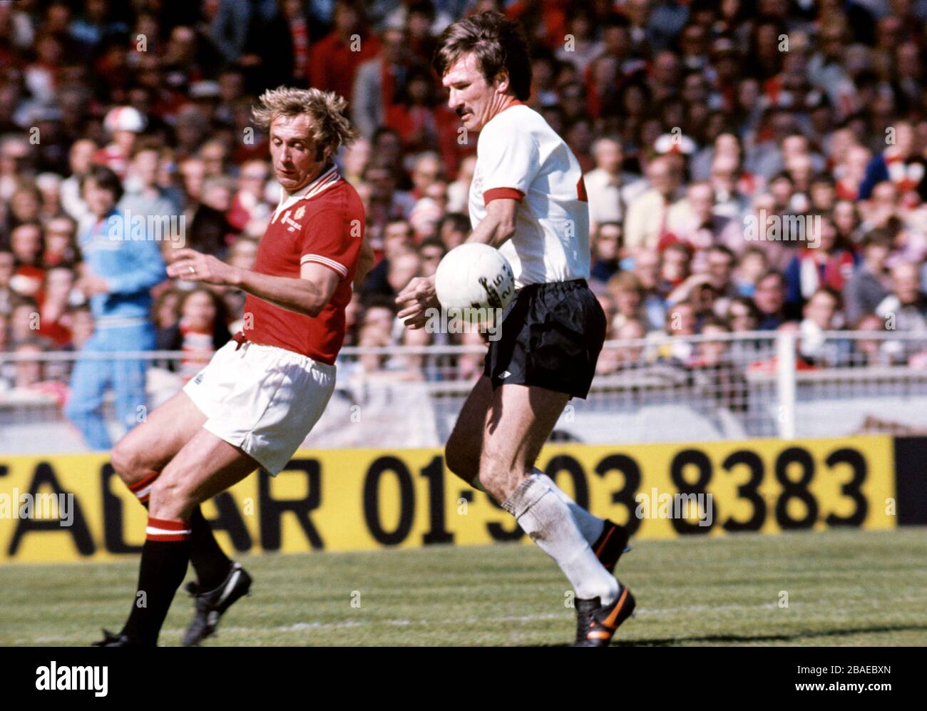 Manchester United's Jimmy Greenhoff (l) and Liverpool's Tommy Smith (r) in action Stock Photo