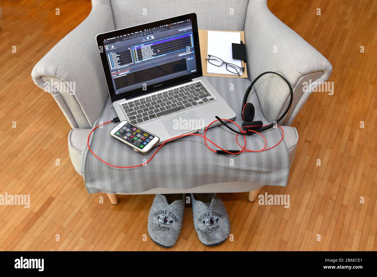 Munich Deutschland 27th Mar 2020 Topic Image Feature Home Office Home Office Teleworking A Laptop With Headset And Mobile Phone Lies On The Seat Of An Armchair The Corona Pandemic Forces Workers