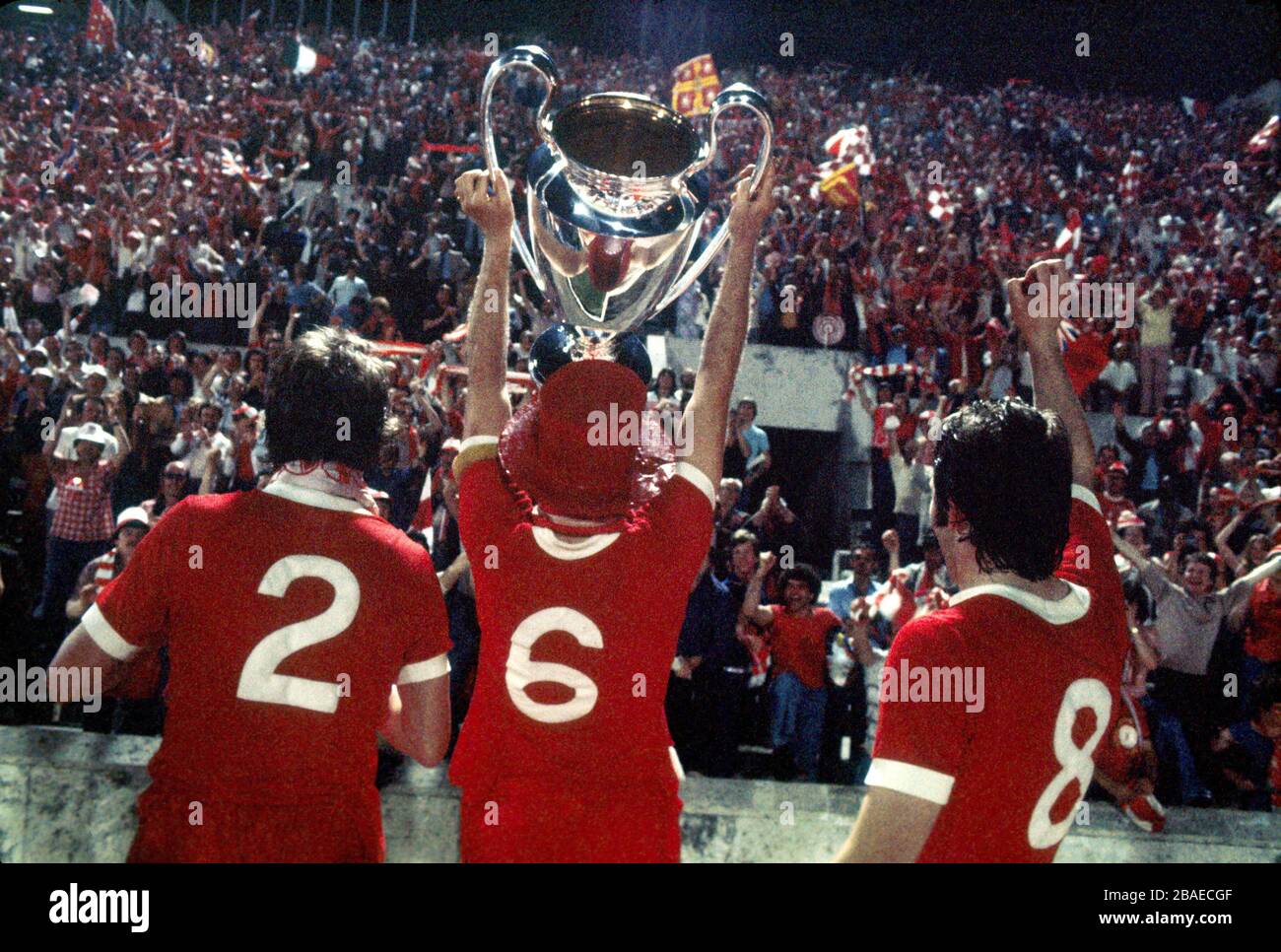 (L-R) Liverpool's Phil Neal, Emlyn Hughes and Jimmy Case show the European Cup to their jubilant fans Stock Photo