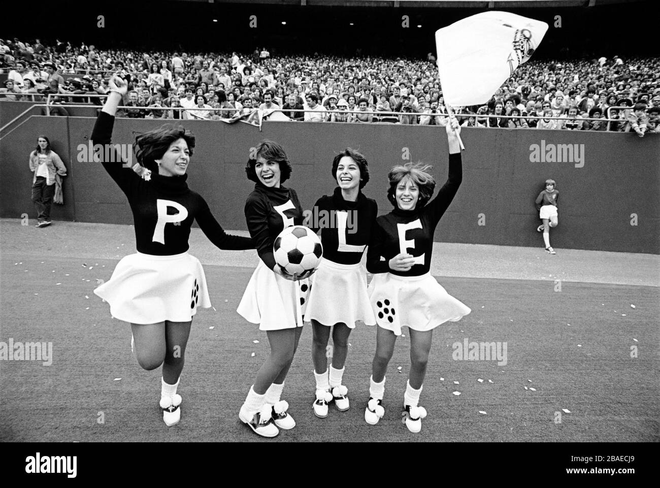 Cheerleaders wait to welcome Pele onto the pitch Stock Photo