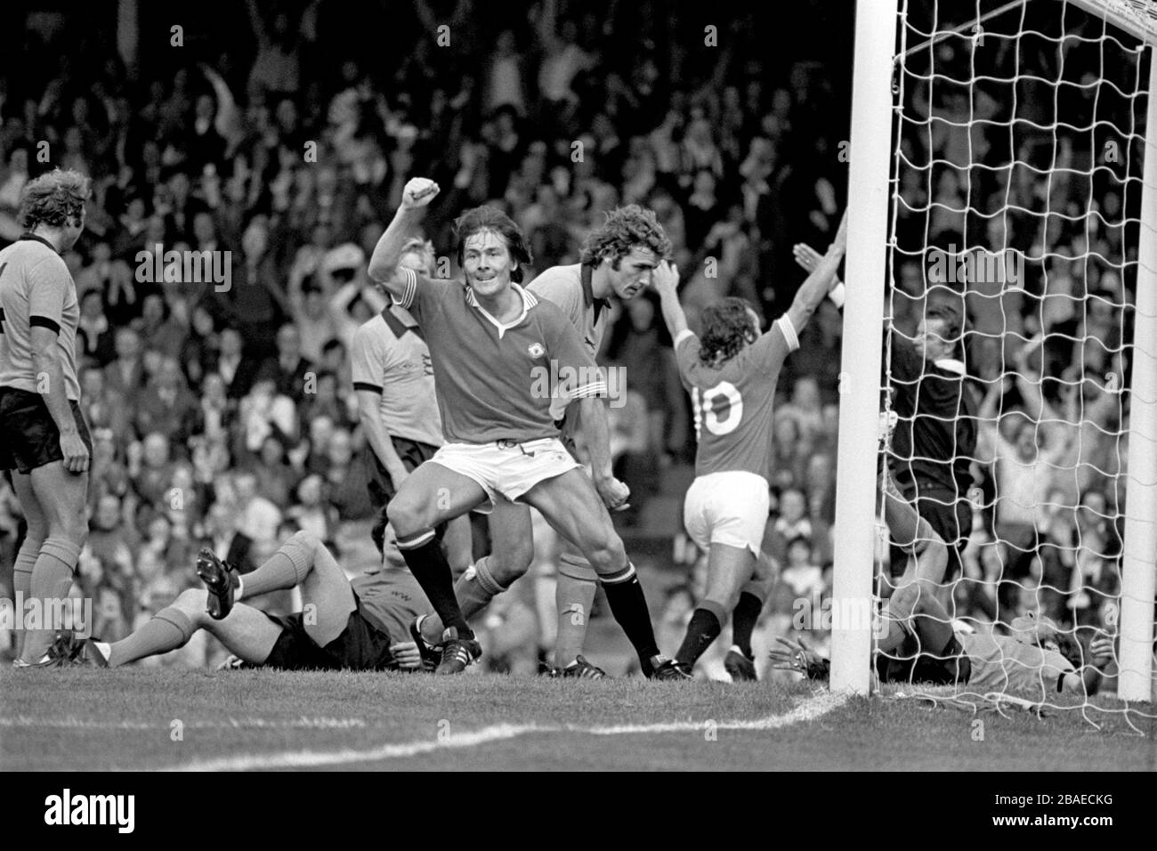 Manchester United's Stuart Pearson (fourth l) and Lou Macari (second r) celebrate the latter's goal, to the disappointment of Wolverhampton Wanderers' Mike Bailey (l), Phil Parkes (second l), Derek Parkin (third l), John McAlle (third r) and Bob McNab (r) Stock Photo