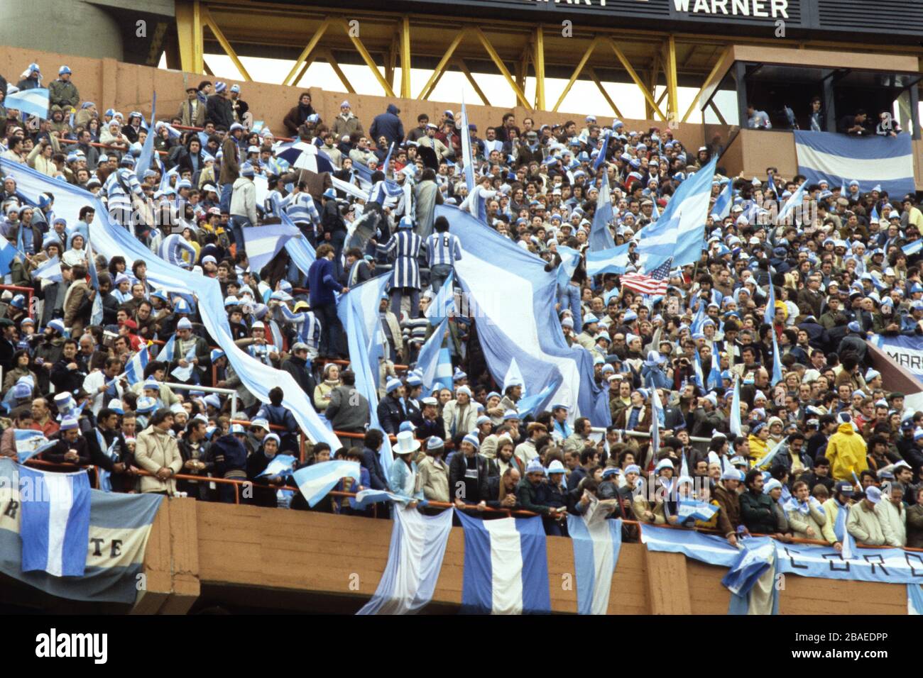Argentina fans waving flags in the stands. Stock Photo