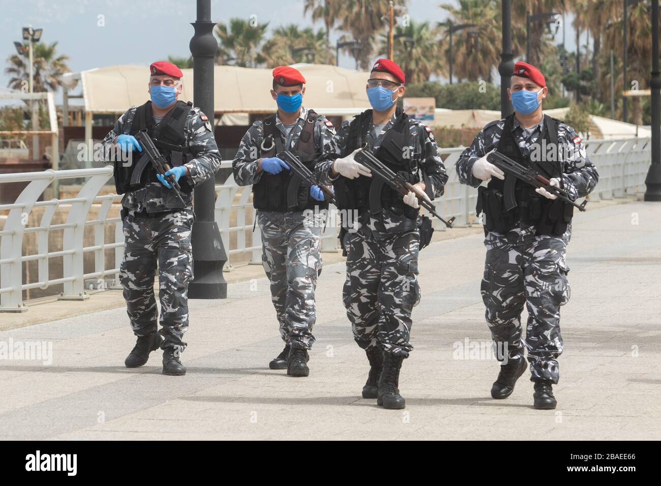Beirut, Lebanon. 27 March 2020. Armed Lebanese police wearing protective gloves and facemasks patrol Beirut seafront to enforce the lockdown and prevent public gatherings as preventive measures to stop the spread of COVID-19 coronavirus. Credit: amer ghazzal/Alamy Live News Stock Photo