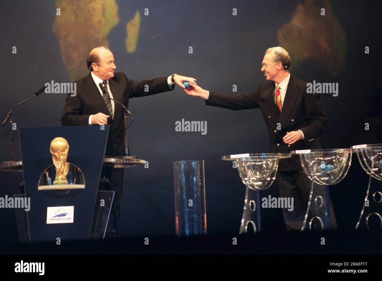 Franz Beckenbauer (right) hands a ball to FIFA general secretary Sepp Blatter (left) Stock Photo