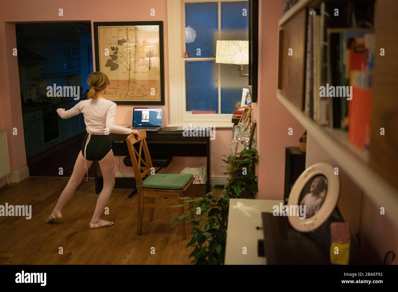 Ivy, 11, participates in a dance class, which has gone online because of coronavirus, in her home in Rickmansworth, Hertfordshire, UK, March 18, 2020 Stock Photo