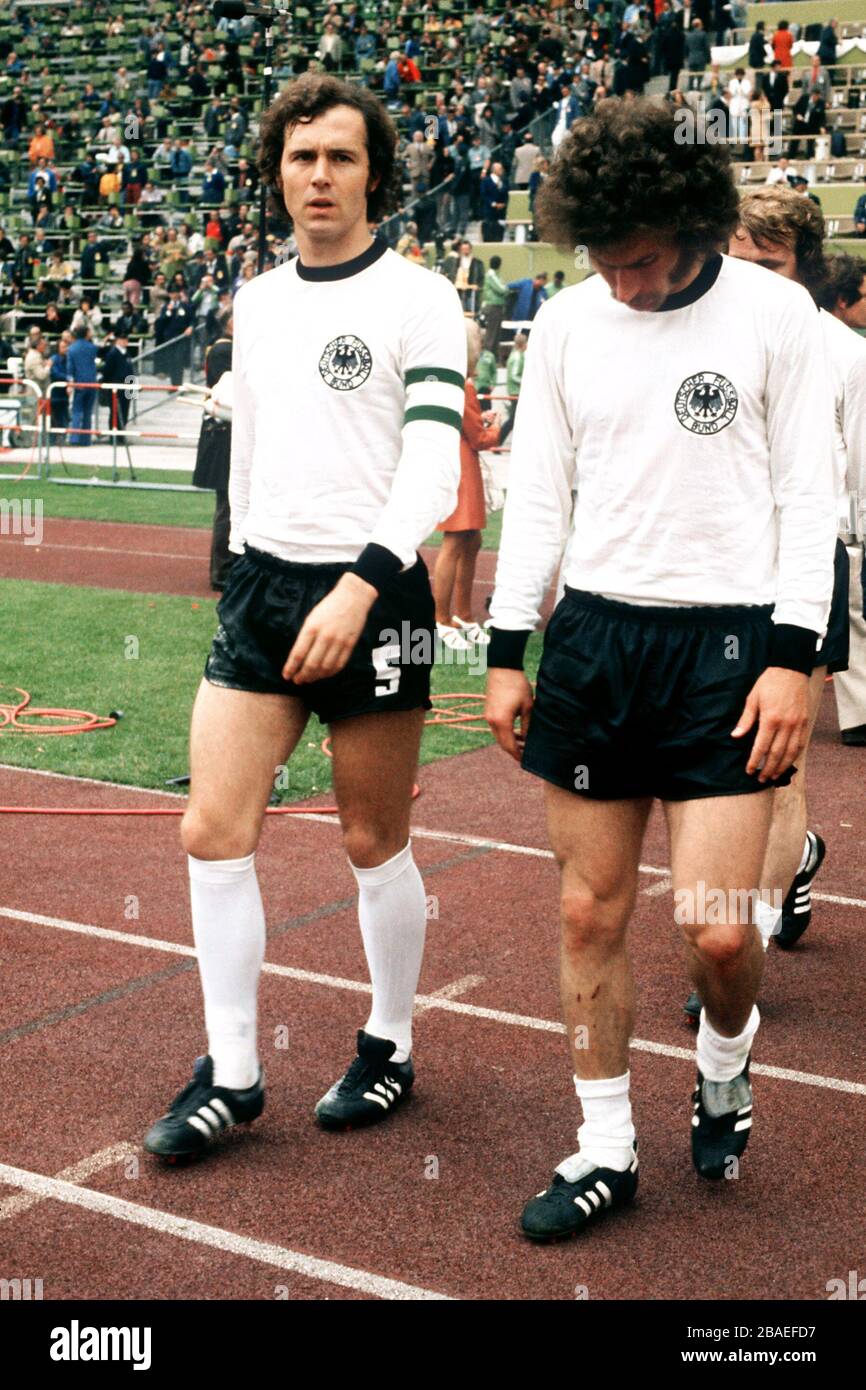 West Germany captain Franz Beckenbauer (left) walks out with teammate Paul Breitner (right) Stock Photo