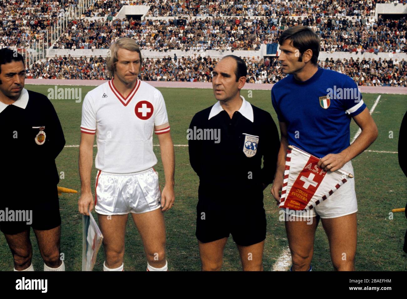 The captains of Switzerland, Karl Odermatt (white shirt), and Italy, Giacinto Facchetti (blue shirt), greet each other before their match in Rome Stock Photo