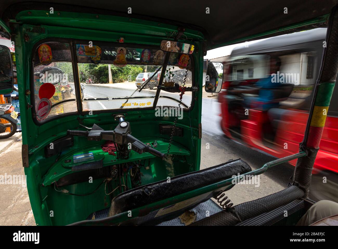 View from inside an auto-rickshaw of traffic passing by in Kandy, Sri Lanka Stock Photo