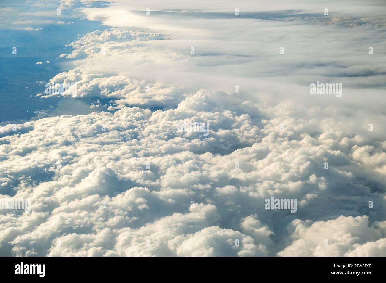 Aerial view of white puffy clouds viewed from an airplane Stock Photo ...