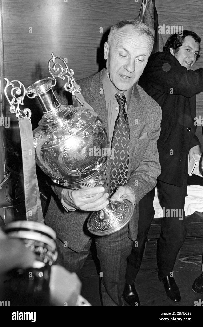 Liverpool manager Bill Shankly takes an admiring look at the Football League Championship trophy after his team gained the required point from their match against Leicester City Stock Photo