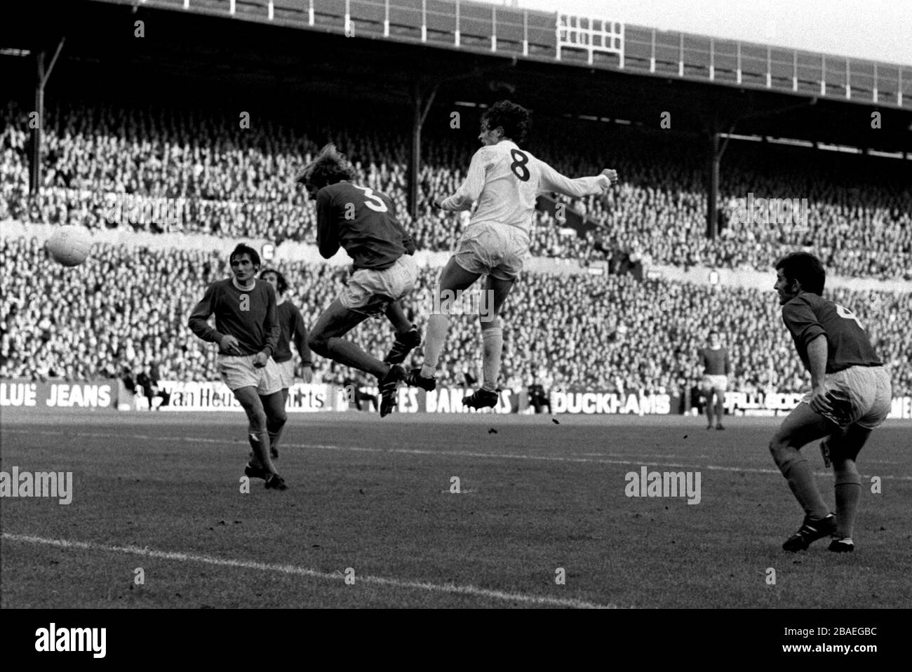 Everton's John Hurst (l) and Henry Newton (r) look on as teammate Keith Newton (second l) is beaten to a header by Leeds United's Allan Clarke (second r) Stock Photo