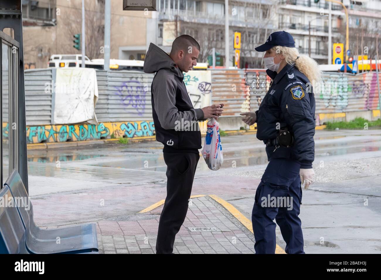 Thessaloniki, Greece - March 23, 2020: A police officer checks the documents of a citizen, as the country struggles to control the spread of the COVID Stock Photo