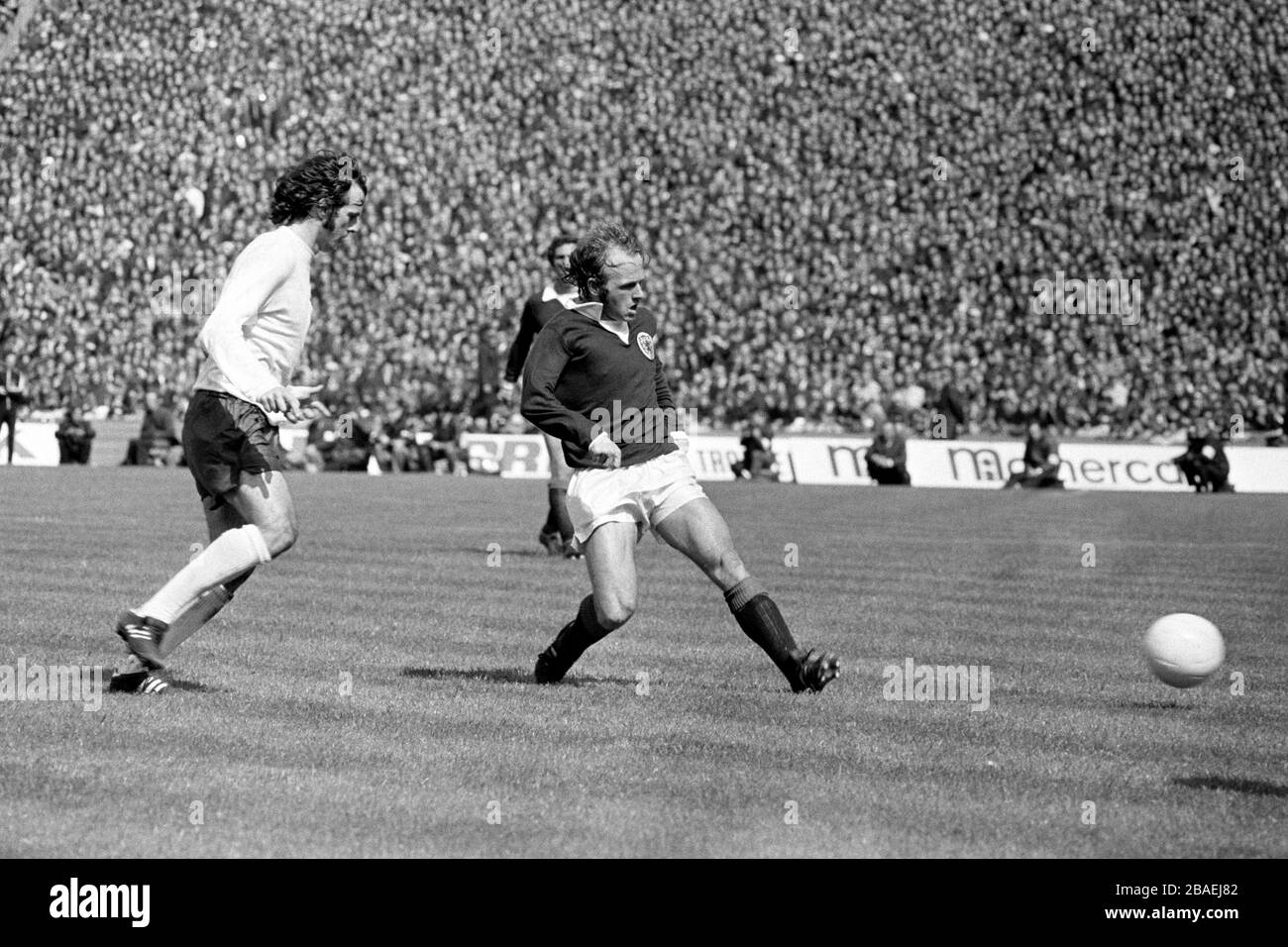 Scotland's Archie Gemmill (r) lays the ball off, watched by England's Peter Storey (l) Stock Photo