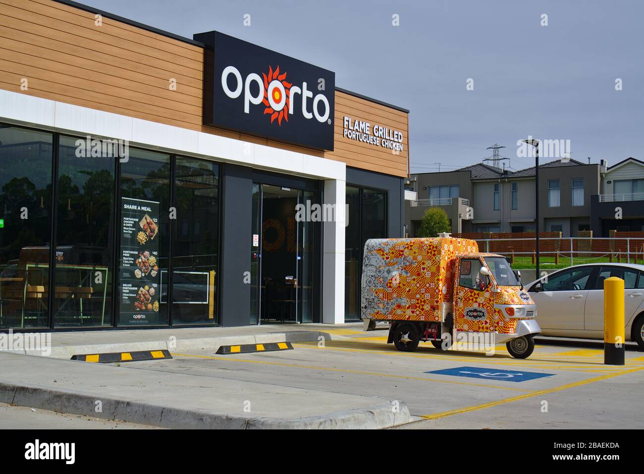 Cranbourne, VIC / Australia - Dec 18 2018: Oporto shop front and its delivery vehicle Stock Photo