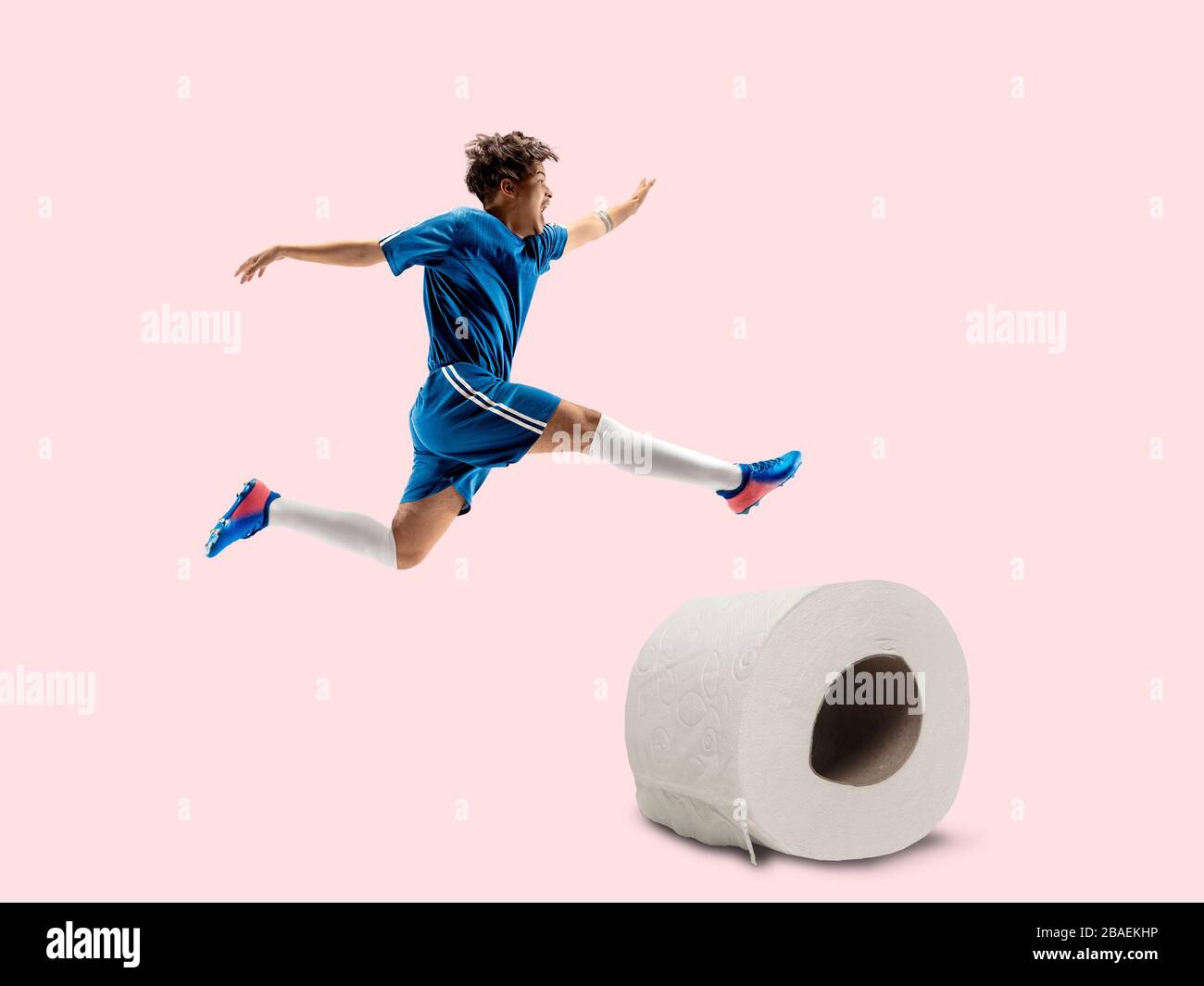 Professional sportsman caught toiletpaper in motion. Reaching target, sport and healthy lifestyle, high demand for essential goods in crisis concept. Competition, championship. Buy enough to be winner. Stock Photo