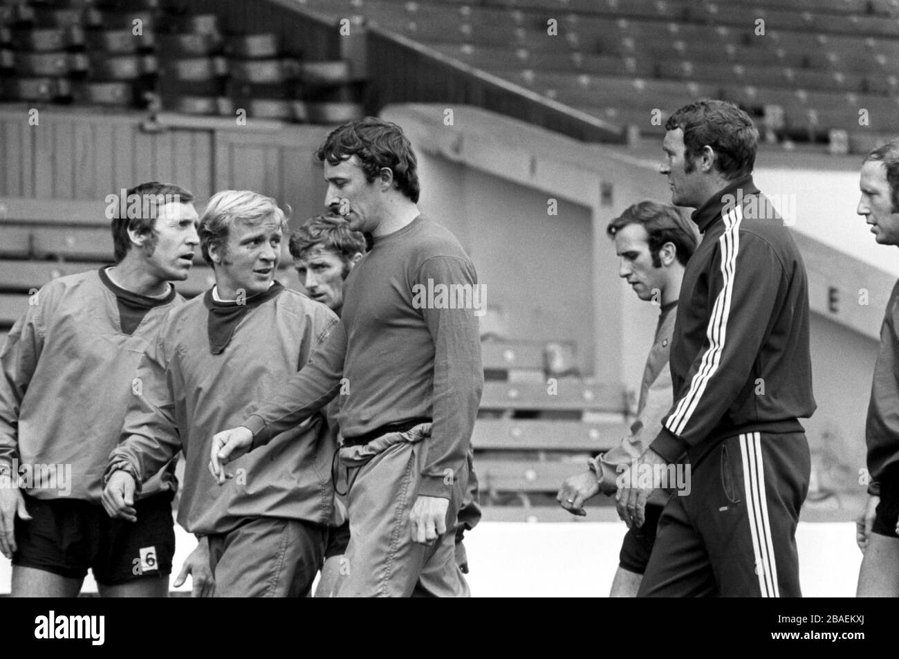 (L-R) Manchester City's Harry Dowd, Francis Lee, Tony Book, Mike Summerbee, Arthur Mann, coach Malcolm Allison and George Heslop warm up with a stroll around Maine Road Stock Photo