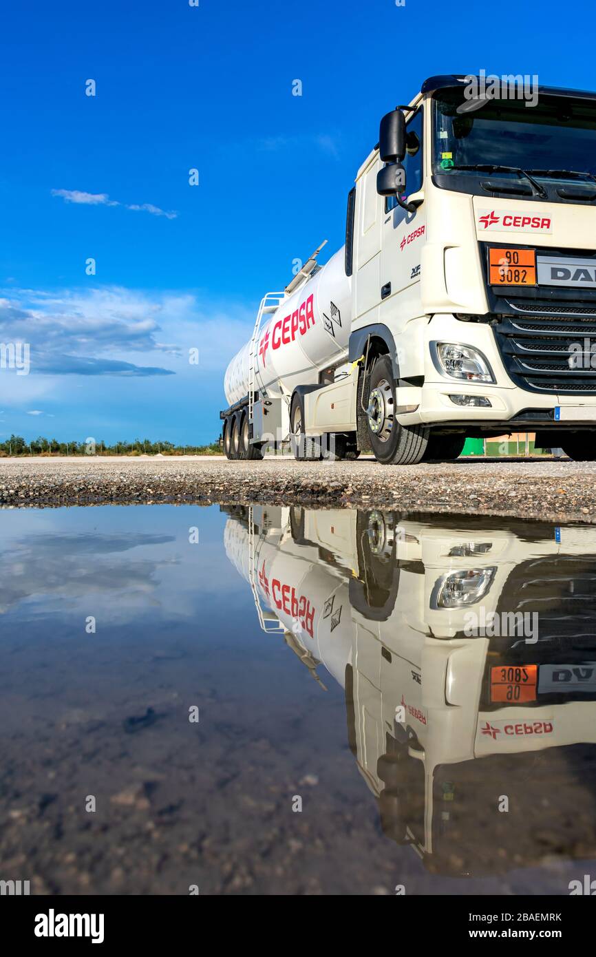 Cepsa oil company marine fuel tanker truck parked and reflected in the water Stock Photo