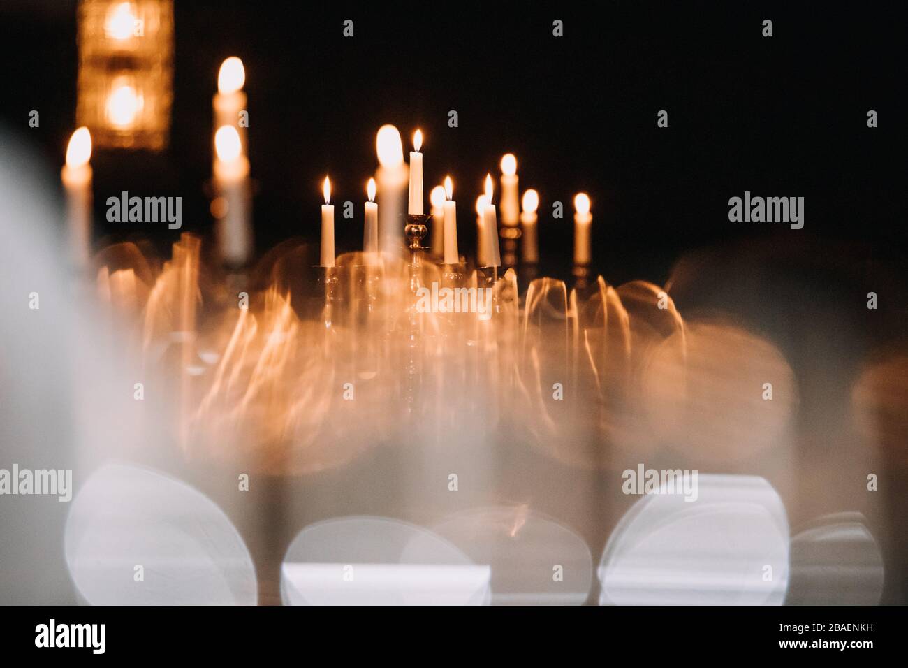 retro candlesticks with burning candles in dark room Stock Photo Alamy