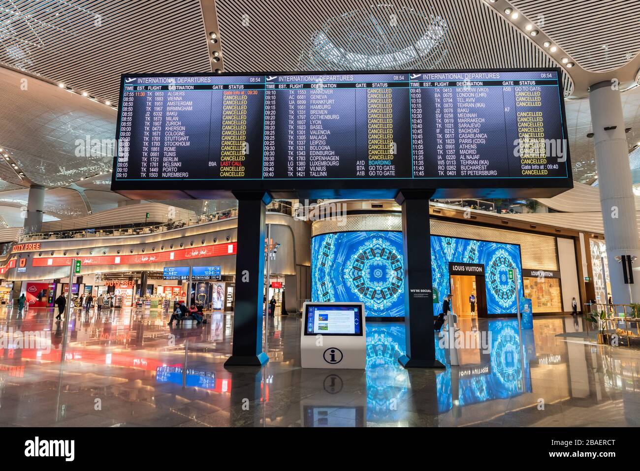 Istanbul, Turkey – March 21, 2020. Screen at deserted departures terminal showing that almost all international departures from Istanbul Airport are c Stock Photo