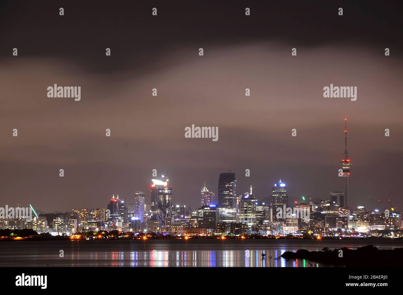 Skyline of Auckland at night seen from the bay Stock Photo