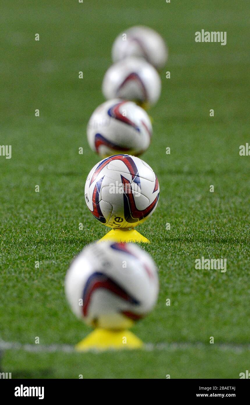 Detail of official Crawley Town Mitre footballs sat on training cones on the pitch before the