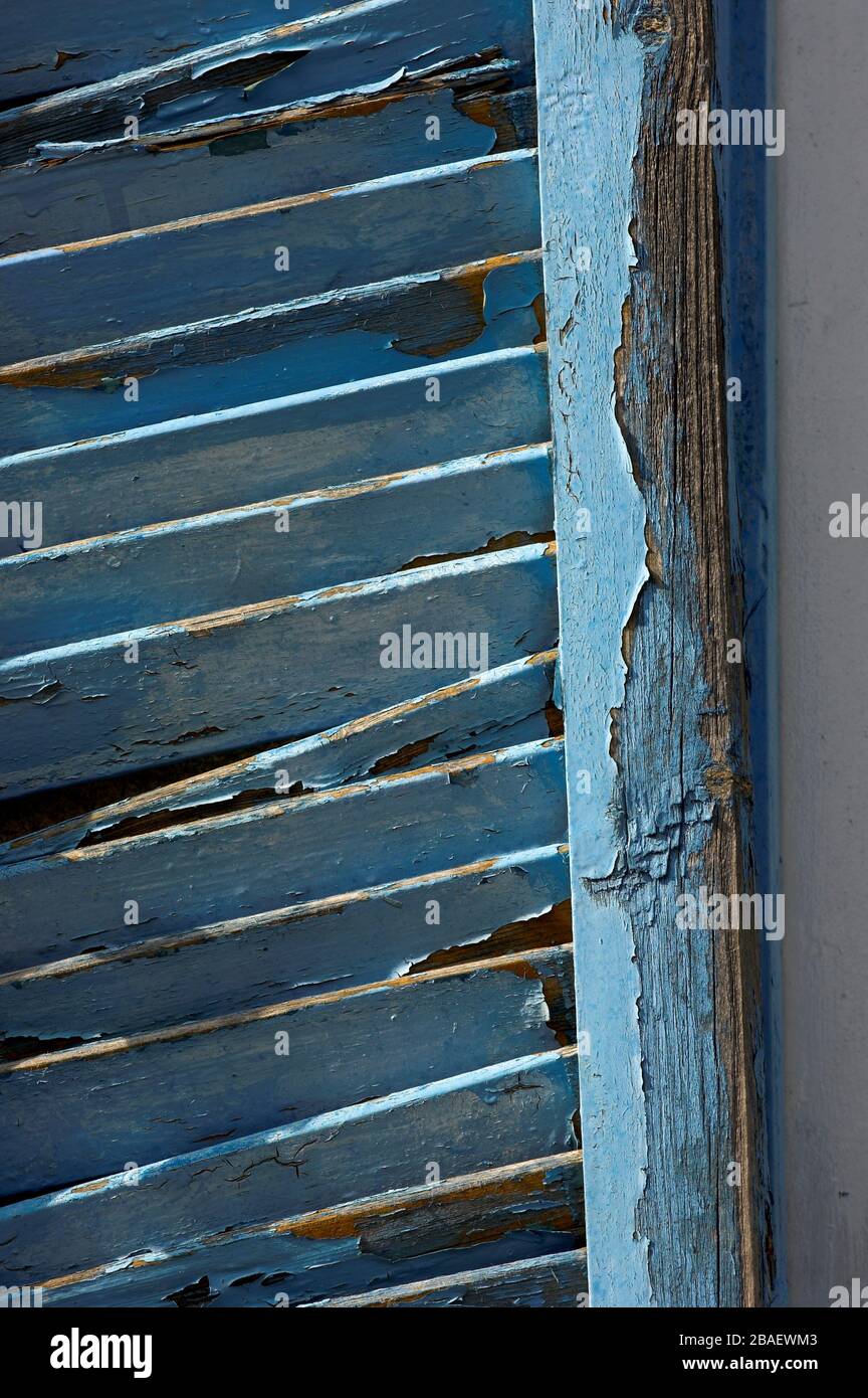 Old window shutters on a house in Cyprus, with blue paint peeling off ...