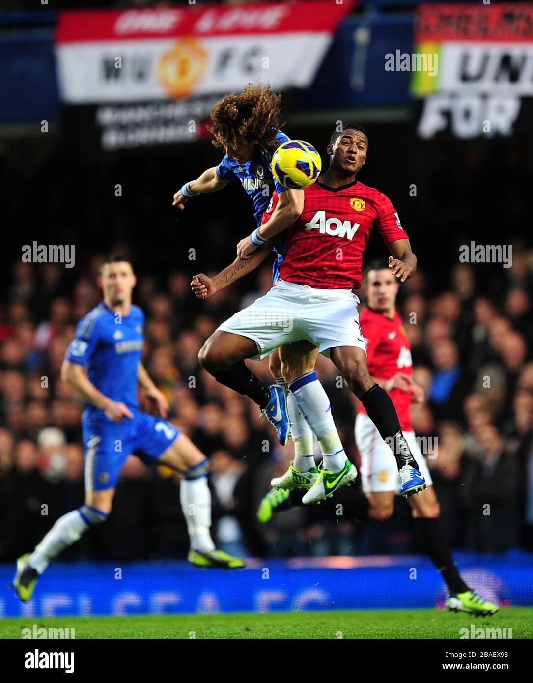 Manchester United's Antonio Valencia (right) and Chelsea's David Luiz battle for the ball in the air Stock Photo