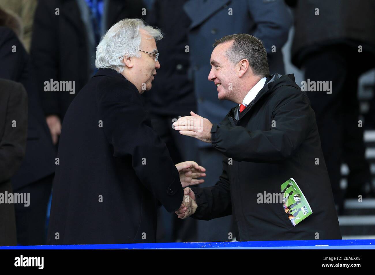 Everton chairman Bill Kenwright (left) shakes hands with Liverpool managing director Ian Ayre (right) in the stands Stock Photo