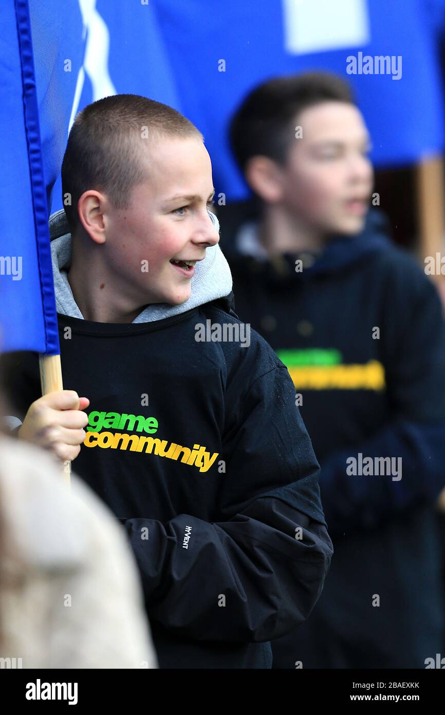 Junior supporters parade Everton flags around the stadium Stock Photo