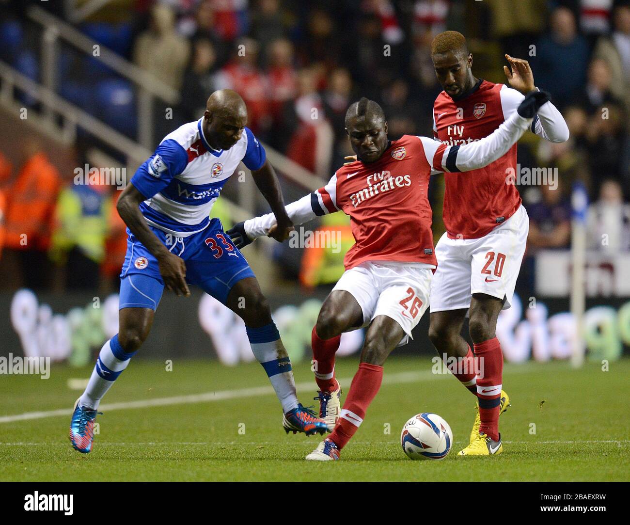 Reading's Jason Roberts (left) battles for the ball with Arsenal's Emmanuel Frimpong (centre) and Johan Djourou (right) Stock Photo