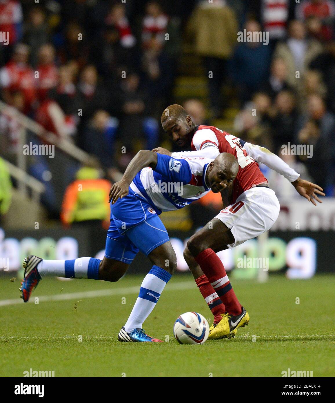 Arsenal's Johan Djourou (right) and Reading's Jason Roberts (left) battle for the ball Stock Photo