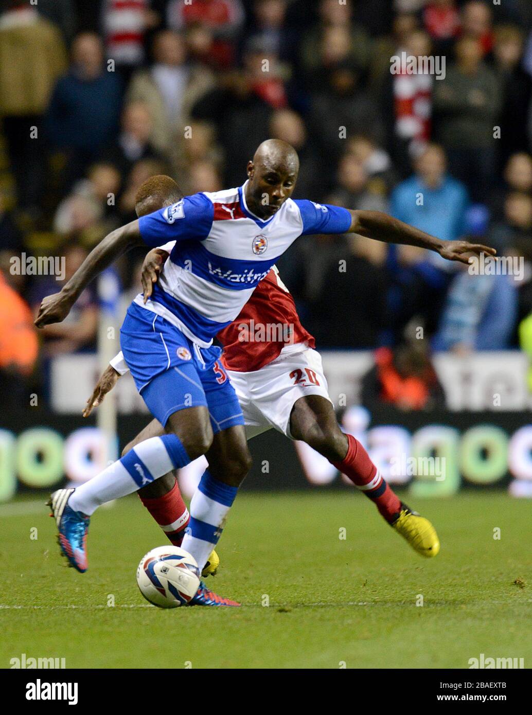 Arsenal's Johan Djourou (rear) and Reading's Jason Roberts (front) battle for the ball Stock Photo