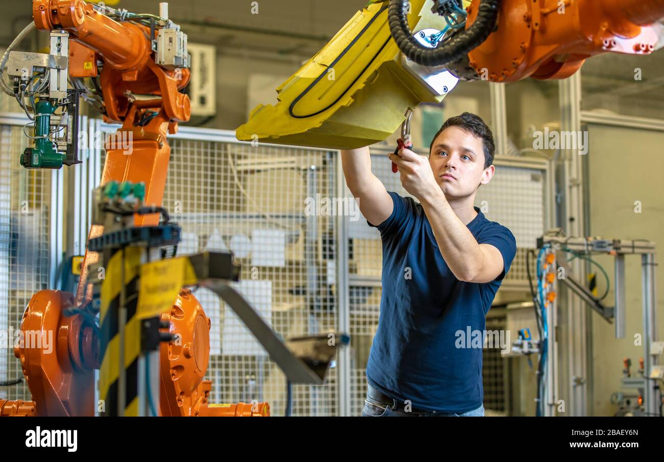 setting up a robotic line with automatic arms before starting the process Stock Photo