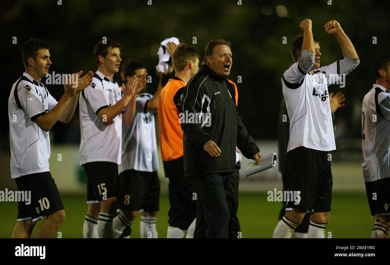 Cambridge City's management and players celebrate at the end of the game Stock Photo