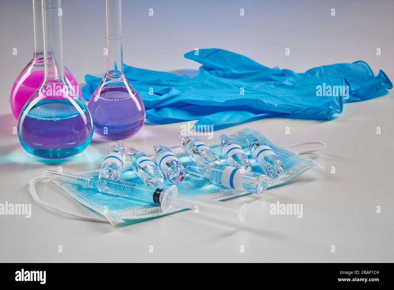 Three medical flasks with purple and pink chemical reagents. Mockup ...