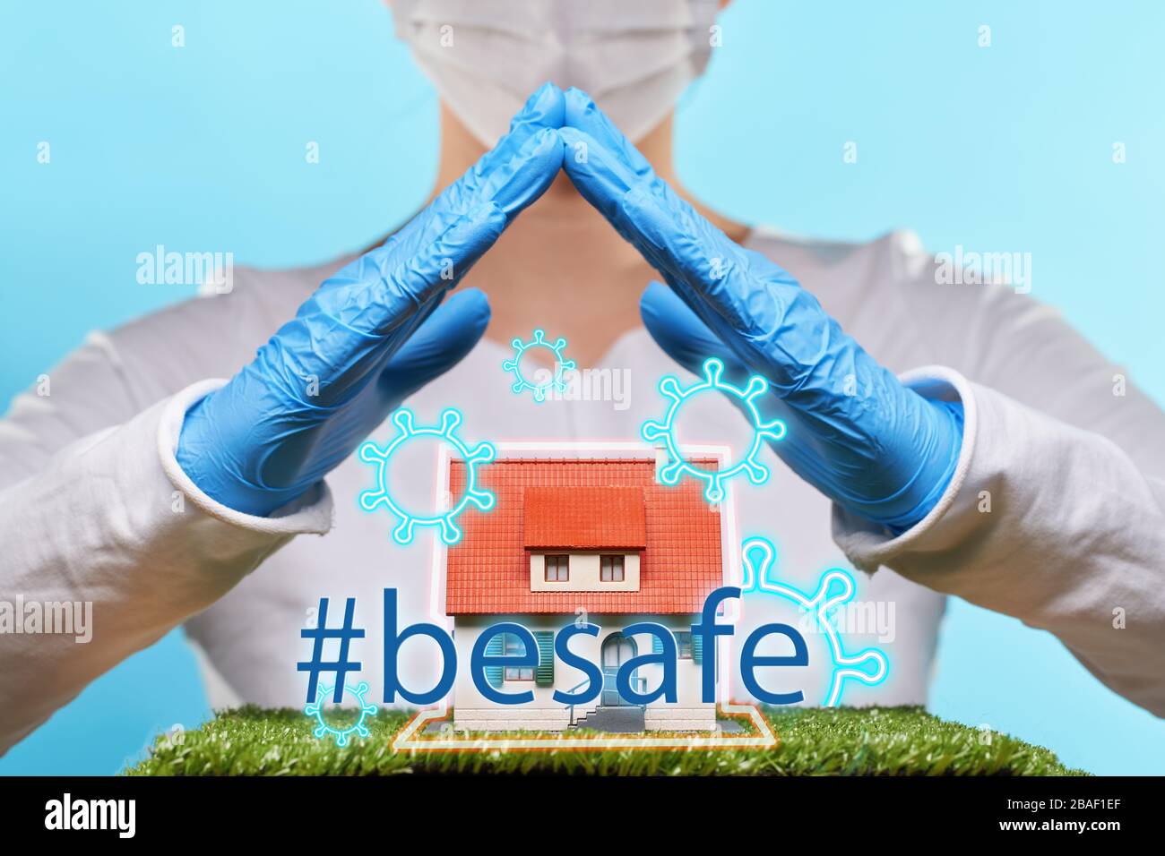 Woman in medical gloves and mask holds hands over a house. Concept of home stay, quarantine, security inside the house. Covid-19 Corona Prevention Mea Stock Photo