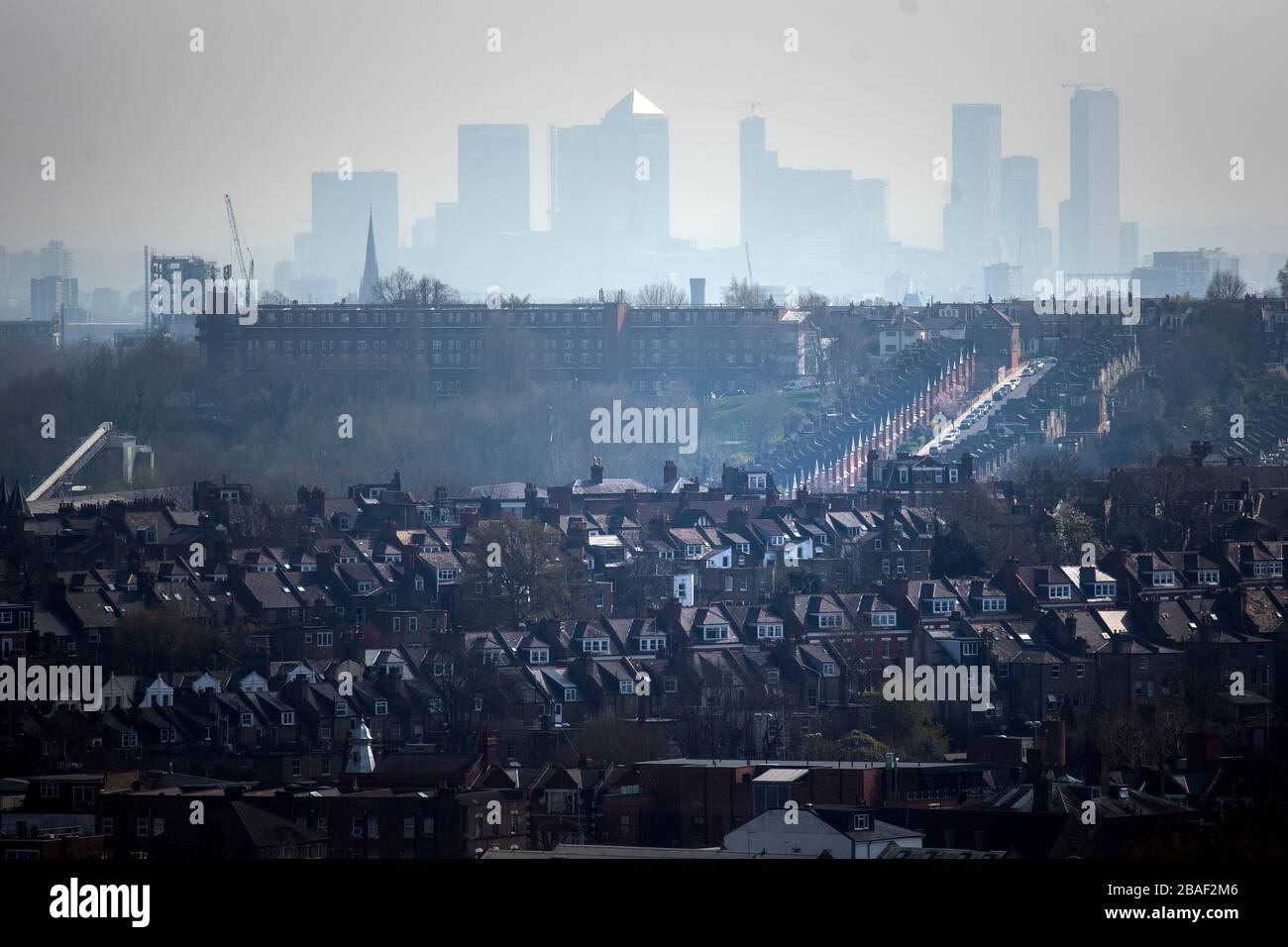 The Canary Wharf skyline viewed through the haze from Alexandra Palace, north London. Stock Photo